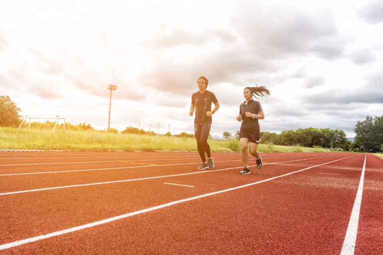 Two runners jogging on the race track, Sport and Social activity concept